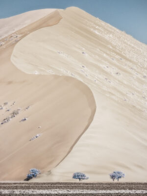 A sandy beach with sand and water on it.