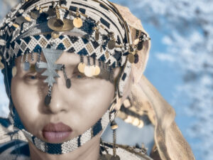 A woman with many coins on her head.