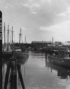 A black and white photo of boats in the water.