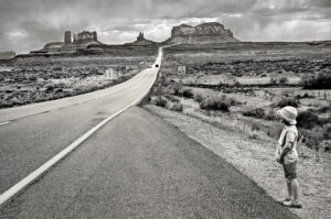 A black and white photo of an empty road
