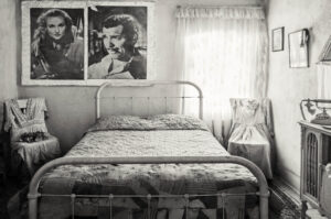 A bed room with two pictures of marilyn monroe on the wall
