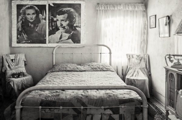 A bed room with two pictures of marilyn monroe on the wall