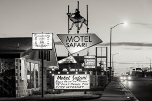 A black and white photo of a motel sign