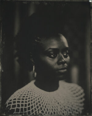 A black and white photo of a woman with short hair.
