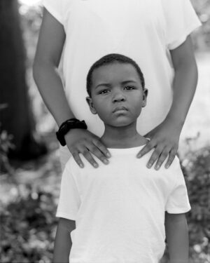 A man and boy standing next to each other.