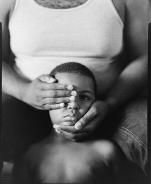 A person covering the face of another person
