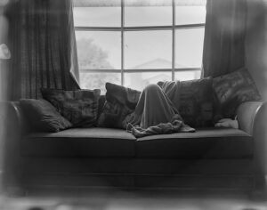 A black and white photo of a window with curtains.