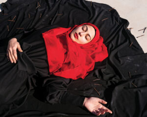 A woman in red is laying on the ground