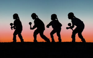 A silhouette of a person swinging a baseball bat.