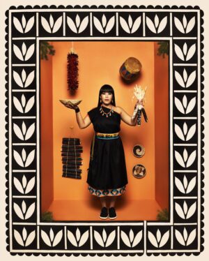 A woman in black dress standing next to various items.