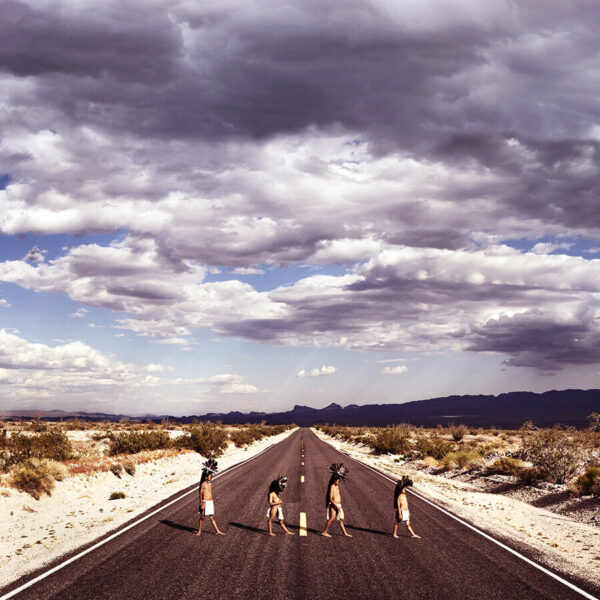 A group of people standing on the side of a road.