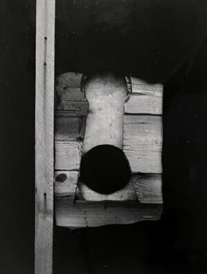 A black and white photo of an open door.