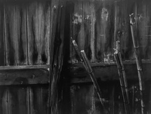 A black and white photo of some wooden poles.