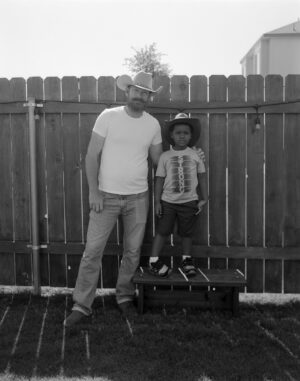 A man and boy standing next to each other.