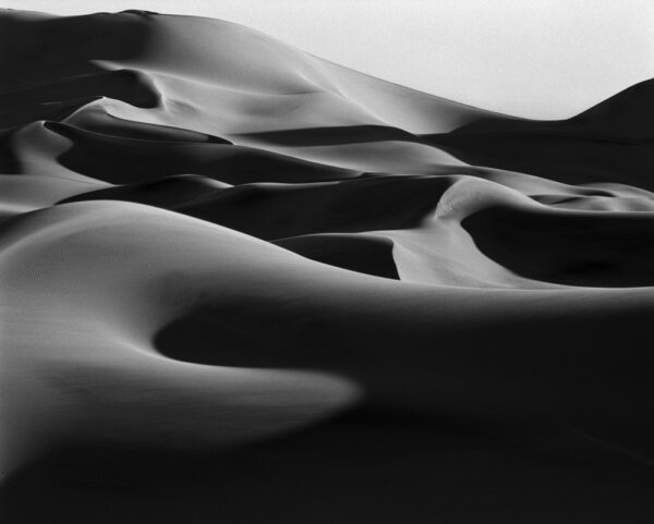 A black and white photo of some sand dunes