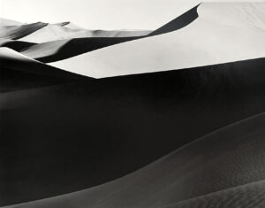 A black and white photo of sand dunes.