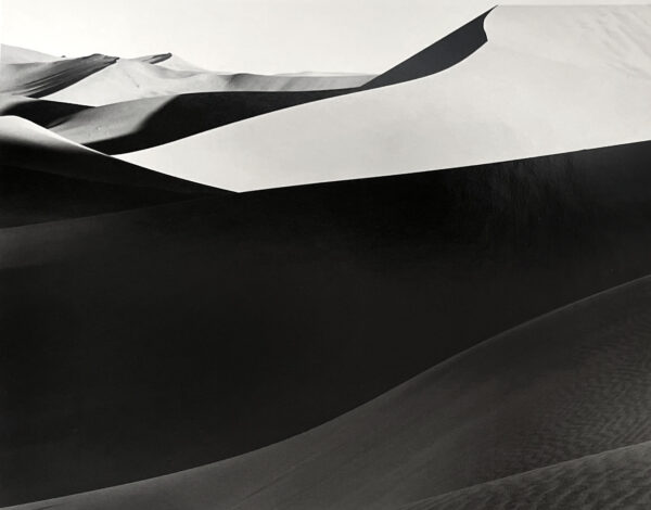 A black and white photo of sand dunes.