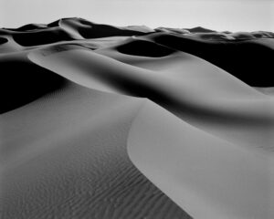 A black and white photo of sand dunes.