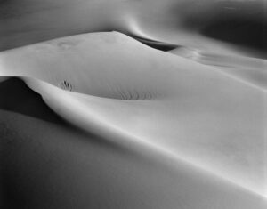 A black and white photo of some sand dunes