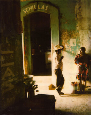 A man and woman standing in an old building.