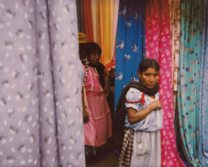 Two girls in dresses and a curtain shop.