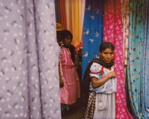 Two girls in dresses and a curtain shop.