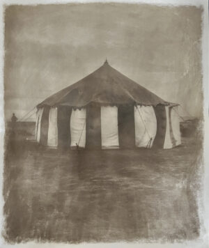 A tent with curtains on the top of it.