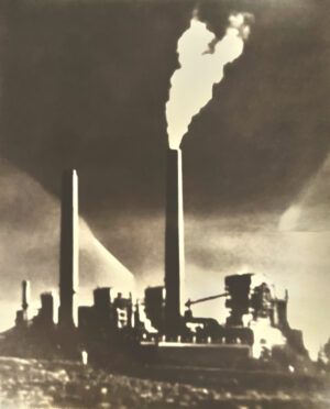 A factory with smoke coming out of the chimney.