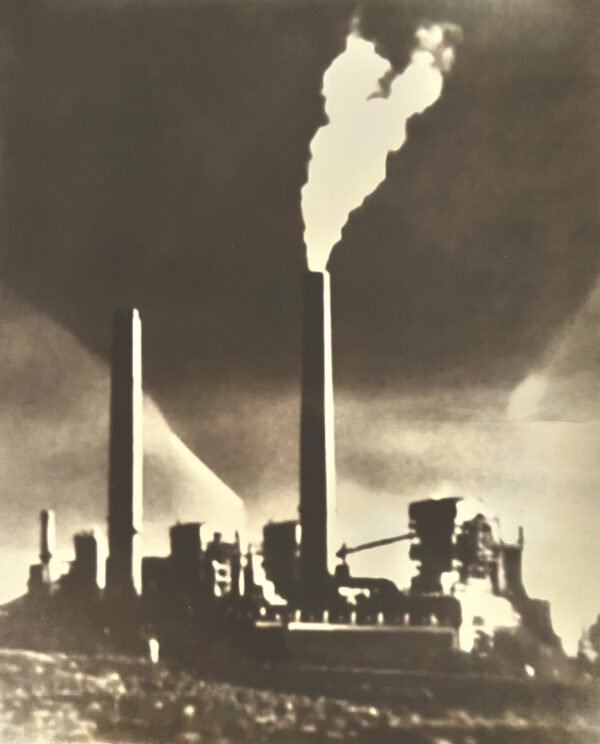 A factory with smoke coming out of the chimney.