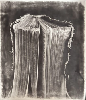 A book is folded in half and has been photographed.