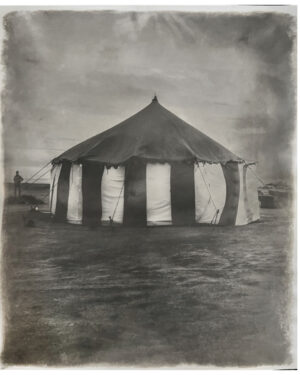 A black and white photo of an old circus tent.