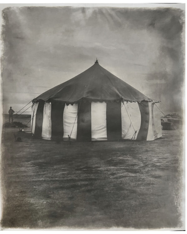 A black and white photo of an old circus tent.