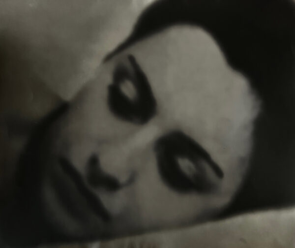 A blurry image of a woman 's face