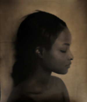 A young girl is looking at the camera.