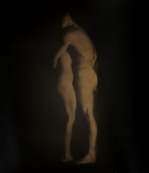 A blurry image of two people standing in the dark.