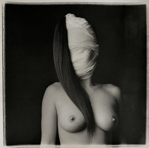 A woman with a bandage covering her face.