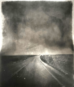 A black and white photo of an empty road
