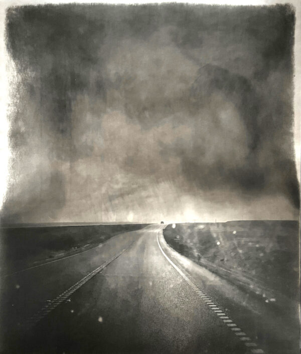 A black and white photo of an empty road