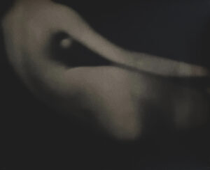 A blurry image of the back side of a woman 's body.