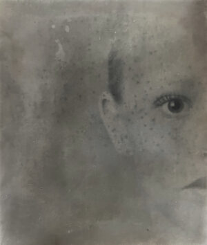 A black and white photo of a child 's face.