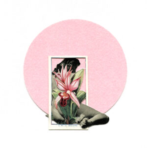 A woman sitting on the ground with a flower in her hand.