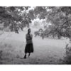 A woman standing in the middle of a field.