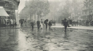 A group of people walking in the rain with umbrellas.