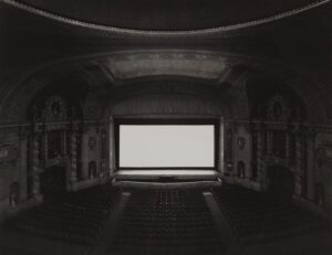 A large screen television in an empty theater.