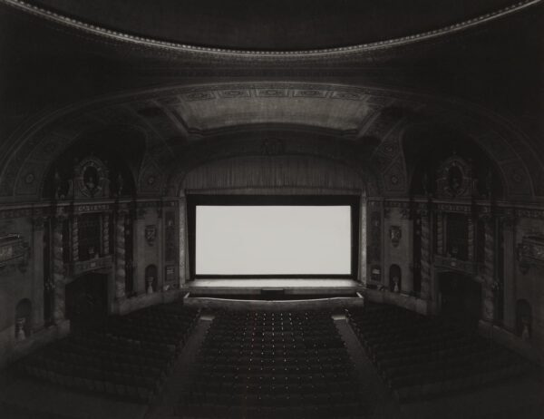 A large screen television in an empty theater.