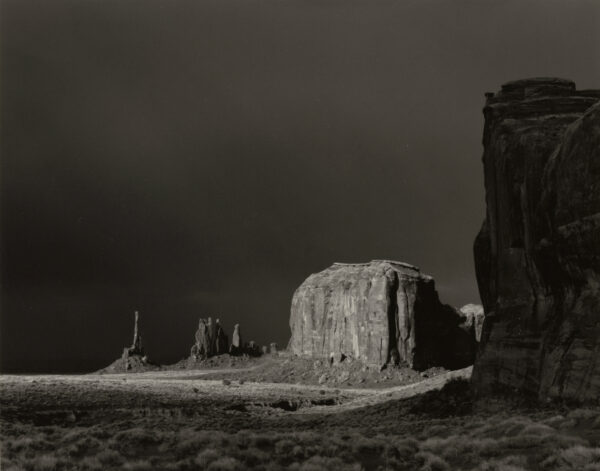 A black and white photo of the monument valley
