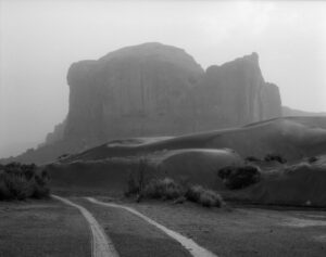 A black and white photo of a road in the middle of nowhere.