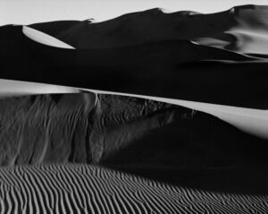 A black and white photo of sand dunes.