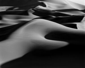 A black and white photo of some sand dunes