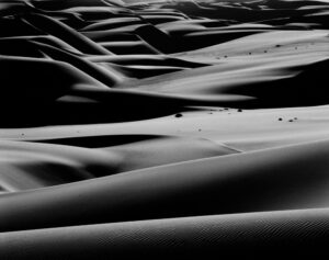 A black and white photo of some sand dunes